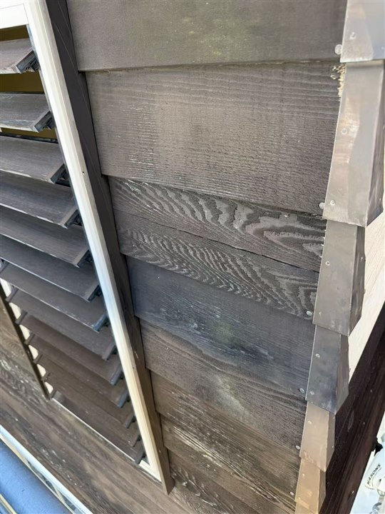Before: weathered exterior boards and corner junction