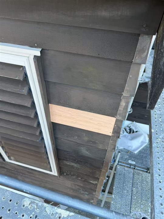 Before: existing boards and a repair patch beside the window